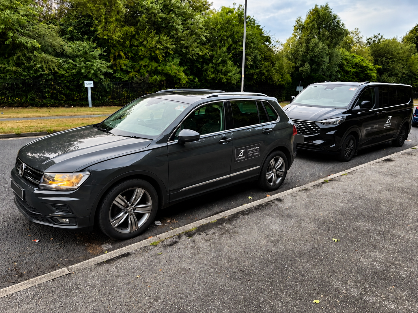 Two Zennfers vehicles parked together with registration plates blanked